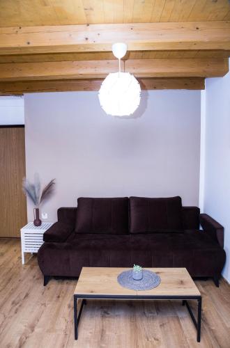 a living room with a couch and a table at Penzion za mlynom in Bešeňová