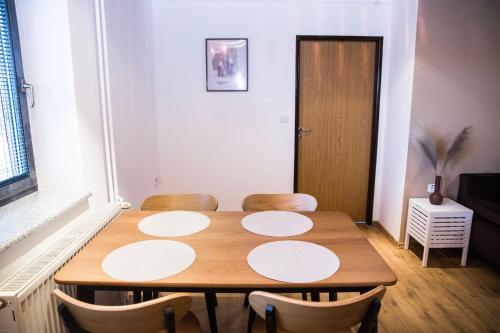 a room with a wooden table and chairs at Penzion za mlynom in Bešeňová