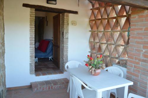 a white table and chairs on a patio at Residence Lucignano in Lucignano