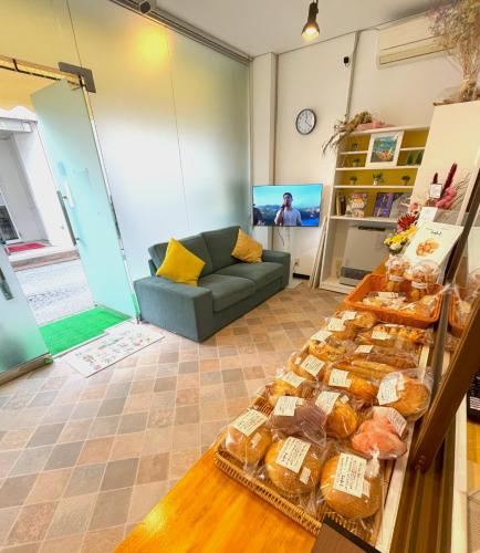 a living room with a table full of pastries at naka-yasumiゲストハウスなかやすみ in Aizuwakamatsu