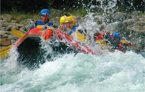 two people in a raft in a river at Holiday Home Heidal Bakketun in Heidal