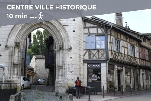 a person sitting in front of a building with an arch at La Girelle -4 pers- Balcon- parking gratuit in Bourg-en-Bresse