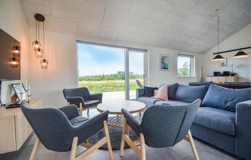 a living room with a couch and chairs and a table at 7 Bedroom Cozy Home In Glesborg in Glesborg