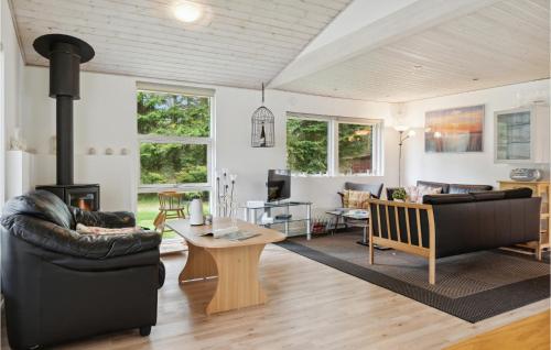 a living room with a couch and a table at Holiday Home Agertoften Løkken V in Løkken