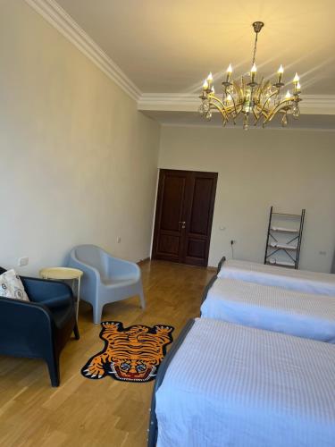 a room with two beds and a chandelier at Velvet Vouge Hostel in Yerevan