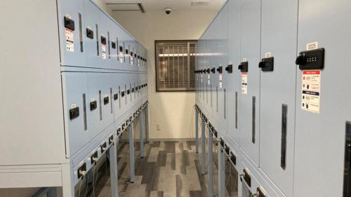 a room with rows of lockers in ansicsnsicsnsicsnsicsnsics at Toyoko Inn Tokyo Shinagawa Konan-guchi Tennozu Isle in Tokyo