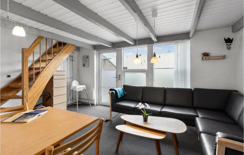 a living room with a couch and a table at Nice Apartment In Hemmet With Sauna in Hemmet