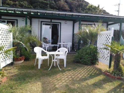 a patio with two white chairs and a table at Pension Le Passage - Vacation STAY 11300v in Tottori
