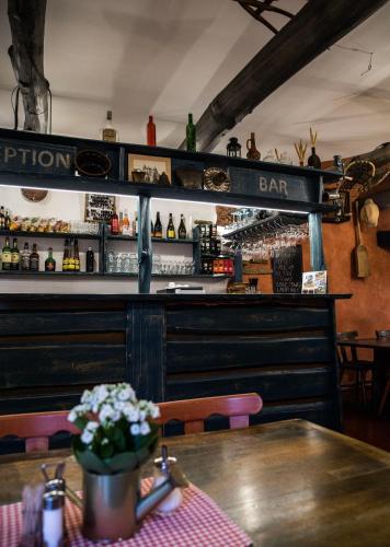 a bar with a wooden table in a restaurant at Penzion za mlynom in Bešeňová