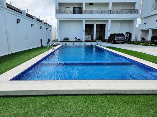 a swimming pool in the yard of a house at America Guest House in Lomé