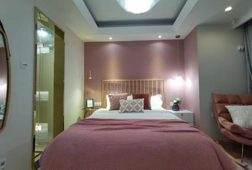 a bedroom with a large bed and a chair at Shanghai Lerongju Boutique Apartment Metro Line 8 20meter in Shanghai