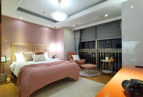 a bedroom with a large bed and a chair at Shanghai Lerongju Boutique Apartment Metro Line 8 20meter in Shanghai