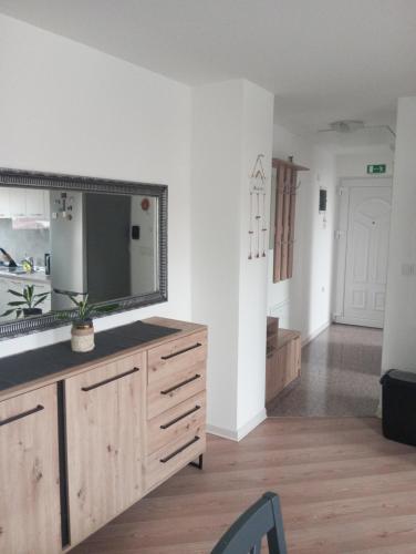 a living room with a large mirror on a dresser at Deniro Apartment in Požega