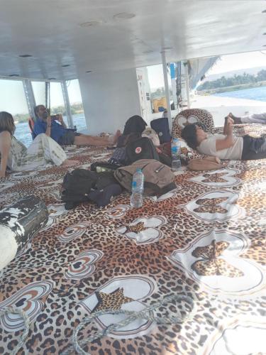a group of people laying on the floor of a boat at Mama Africa Felucca in Aswan