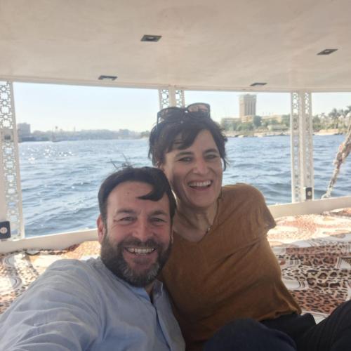 a man and woman sitting on the back of a boat at Mama Africa Felucca in Aswan