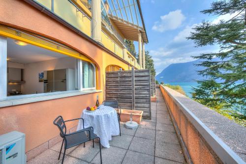 a table and chairs on the balcony of a building at Cortivo Apartments in Castagnola