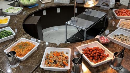 a table topped with bowls of food on a counter at Toyoko Inn Tokyo Shinagawa Konan-guchi Tennozu Isle in Tokyo
