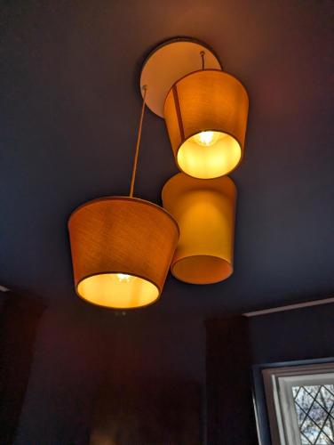 a couple of lights hanging from a ceiling at The Duke Hotel in Hilmarton