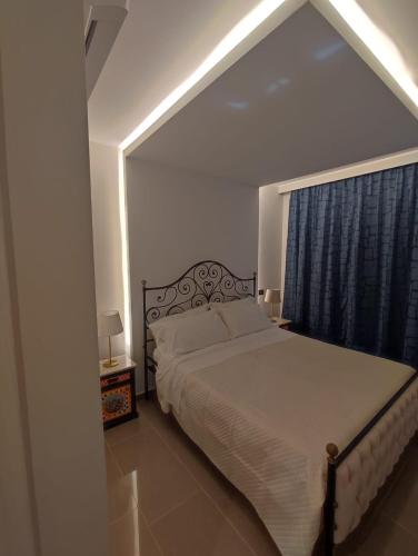 a bedroom with a large bed and a window at IG - "Villa Don Antonio" Apartments in Giardini Naxos