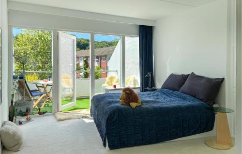 a dog sitting on a bed in a bedroom at Cozy Apartment In Helsingør With Wifi in Helsingør