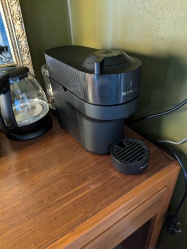 a coffee maker sitting on top of a wooden table at The Duke Hotel in Hilmarton