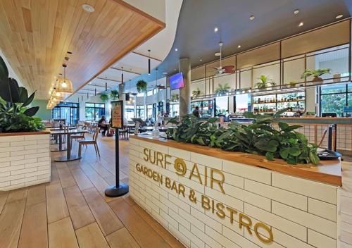 a restaurant with a counter with plants on it at Coastal Calm Studio - A Private Studio with a Personal Touch in Marcoola