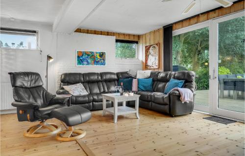 a living room with a leather couch and chairs at Lovely Home In Gørlev With Kitchen in Gørlev