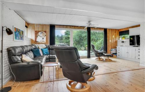 a living room with a leather couch and chairs at Lovely Home In Gørlev With Kitchen in Gørlev