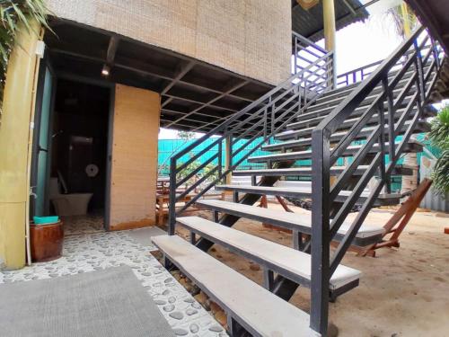 a set of stairs in a building next to a building at Hành Ngò Homestay - Hòn Đỏ Ninh Thuận in Thôn Dư Khánh
