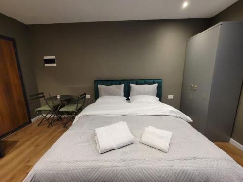 a large bed with two white pillows on it at Selen GuestHouse in Tirana