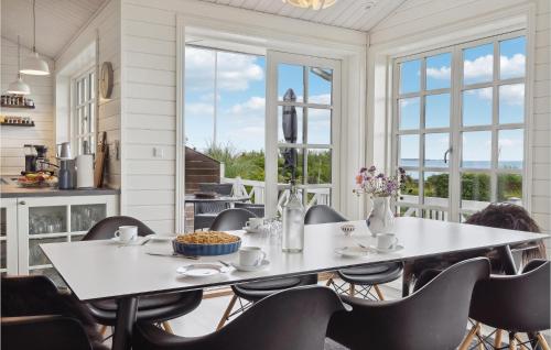a dining room with a table and chairs at 3 Bedroom Stunning Home In Hejls in Hejls
