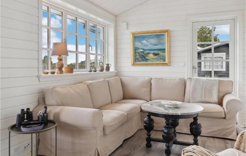 a living room with a couch and a table at 3 Bedroom Stunning Home In Hejls in Hejls