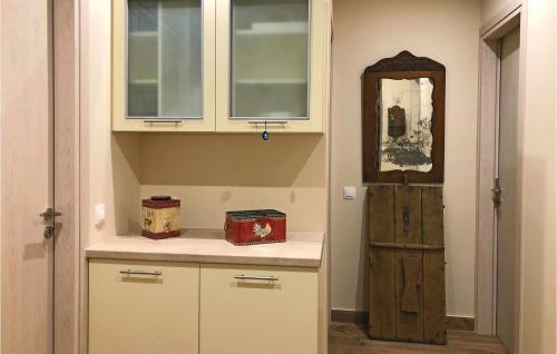 a kitchen with white cabinets and a wooden door at Maison Elia With Private Pool in Kardamili