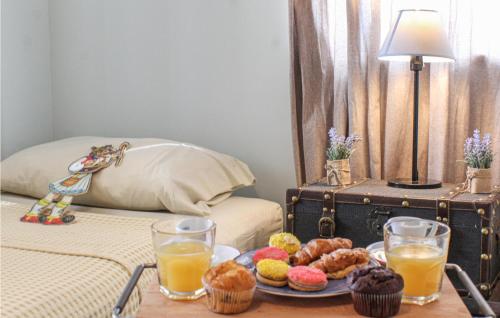a table with a tray of donuts and drinks on a bed at Maison Elia With Private Pool in Kardamili