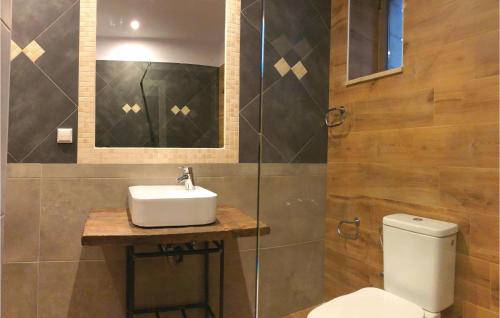 a bathroom with a sink and a toilet at Maison Elia With Private Pool in Kardamili