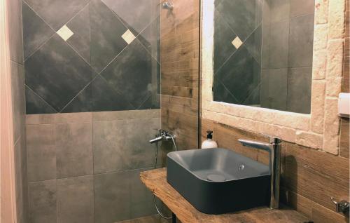 a bathroom with a sink and a mirror at Maison Elia With Private Pool in Kardamili