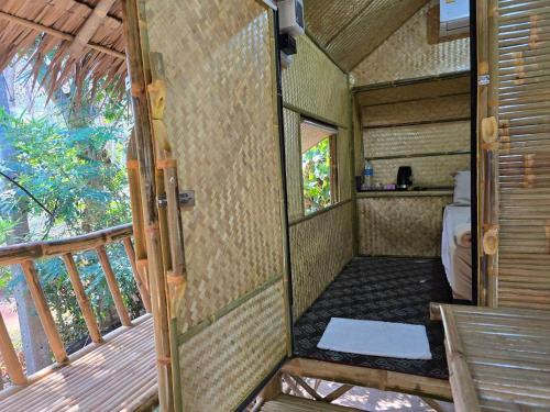 an outside view of a bedroom in a tiny house at Campchamao in Ban Ra-ok