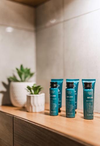 four blue bottles on a wooden shelf with a plant at Bacówka Polany in Polany