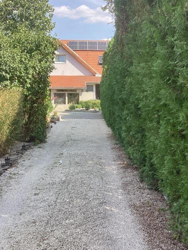 a gravel road in front of a house at Relax Apartman in Sümeg