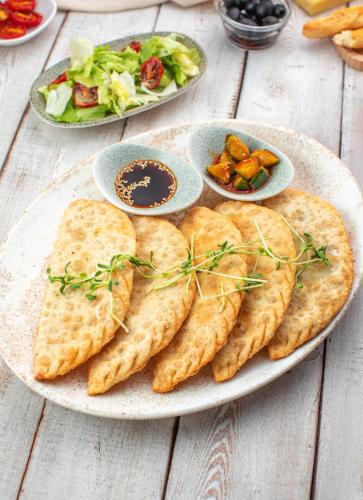 a plate of food with pita bread and a salad at Khangain Tugul Hotel in Tsetserleg