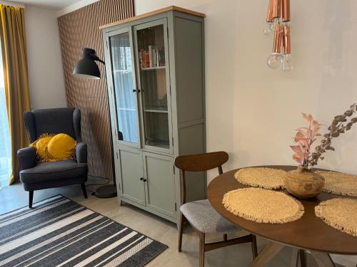 a dining room with a table and a chair at Kal's Studio Apartment Salzburg in Salzburg