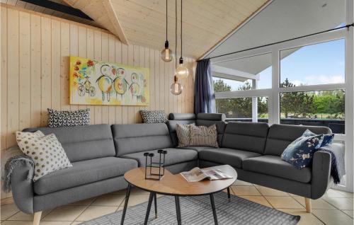 a living room with a couch and a table at 3 Bedroom Amazing Home In Hemmet in Hemmet