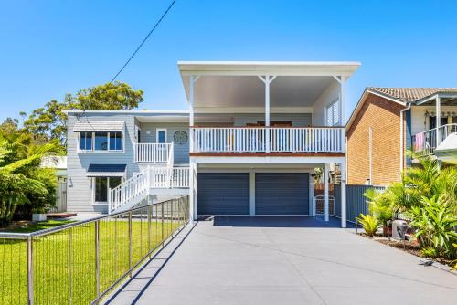 a house with a gate and a driveway at Shoaly House and Shoaly House Cottage - perfect for multiple families & wedding groups in Shoal Bay