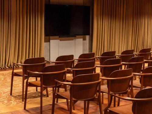 a row of chairs in a room with a screen at Mondrian Bordeaux Les Carmes in Bordeaux