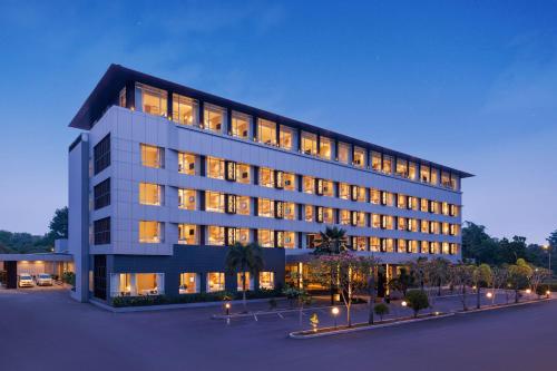 a large building with many windows at night at Hotel Santika Lahat in Lahat