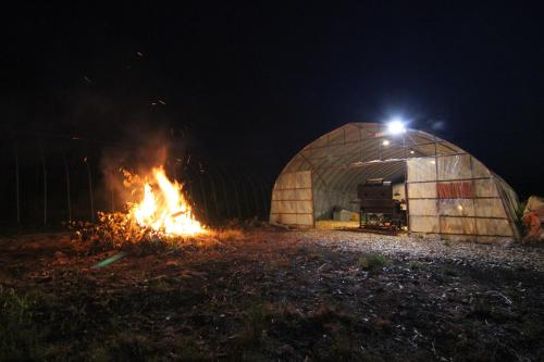 a fire in a greenhouse at night at Furano Cottage Shelter in Nakafurano