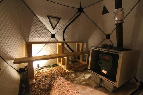 a small stove in a room with a window at Furano Cottage Shelter in Nakafurano