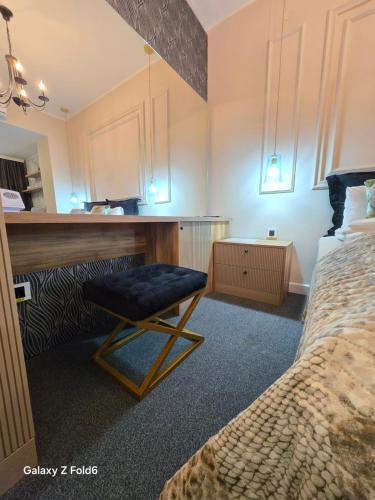 a bedroom with a bed and a chair in a room at Face 1 Center SUBOTICA in Subotica