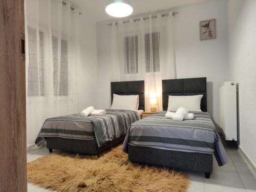 Postel nebo postele na pokoji v ubytování TASSOS Gesthouse