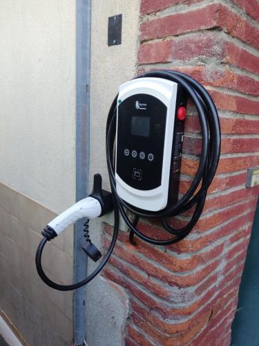 a cell phone is plugged into a brick wall at Gîte de la confluence in Padern